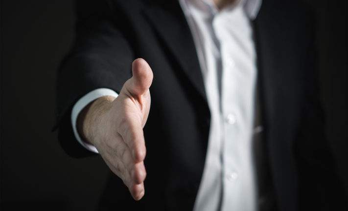 Salesperson extending hand to shake hands